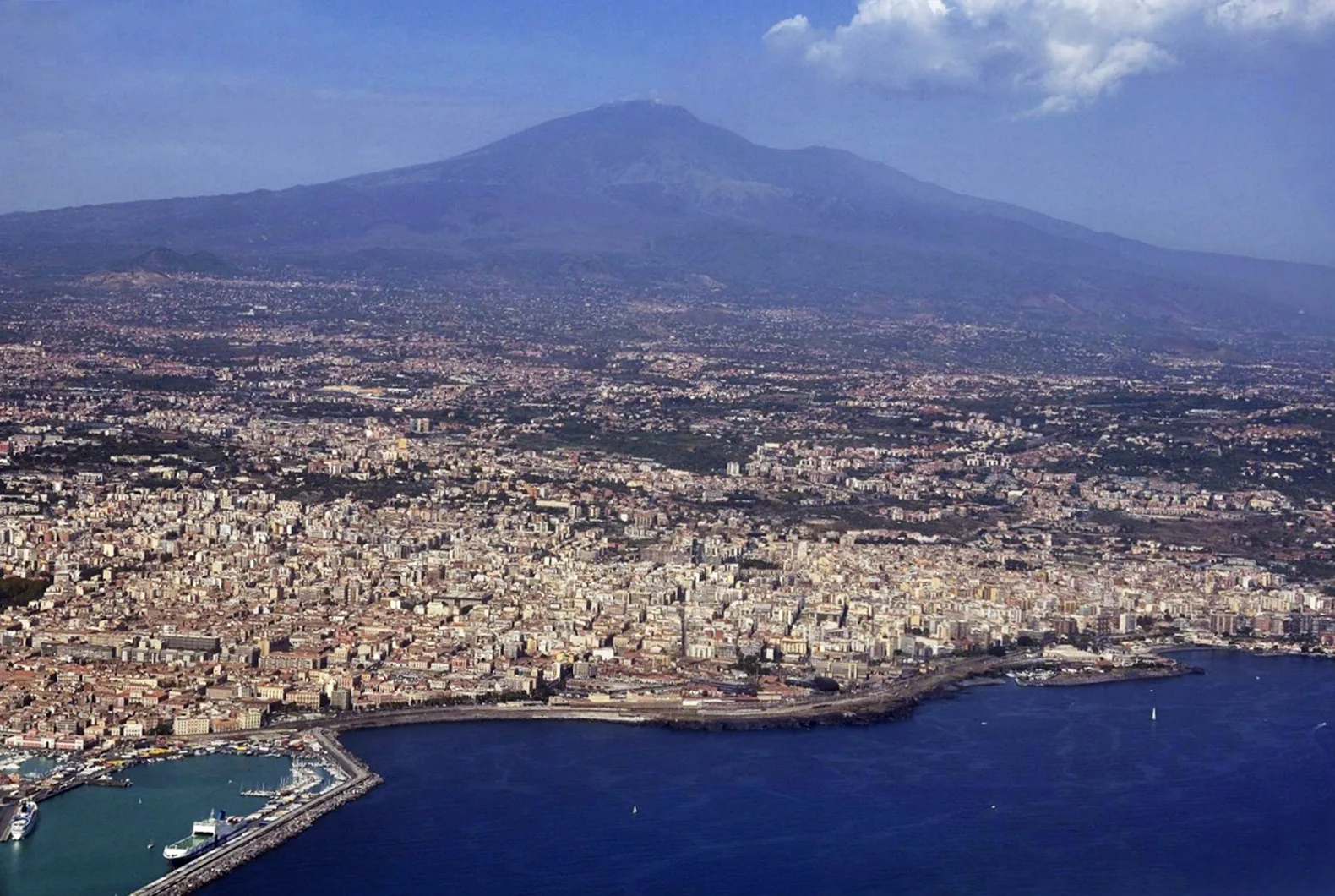Aerial view of Catania city with Mount Etna volcano in the background, Sicily