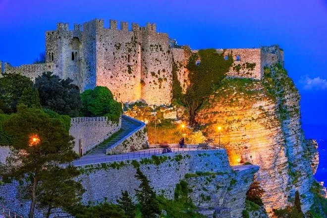 Atmospheric sunset view across the historic stone fortifications and Mediterranean Sea from Erice.