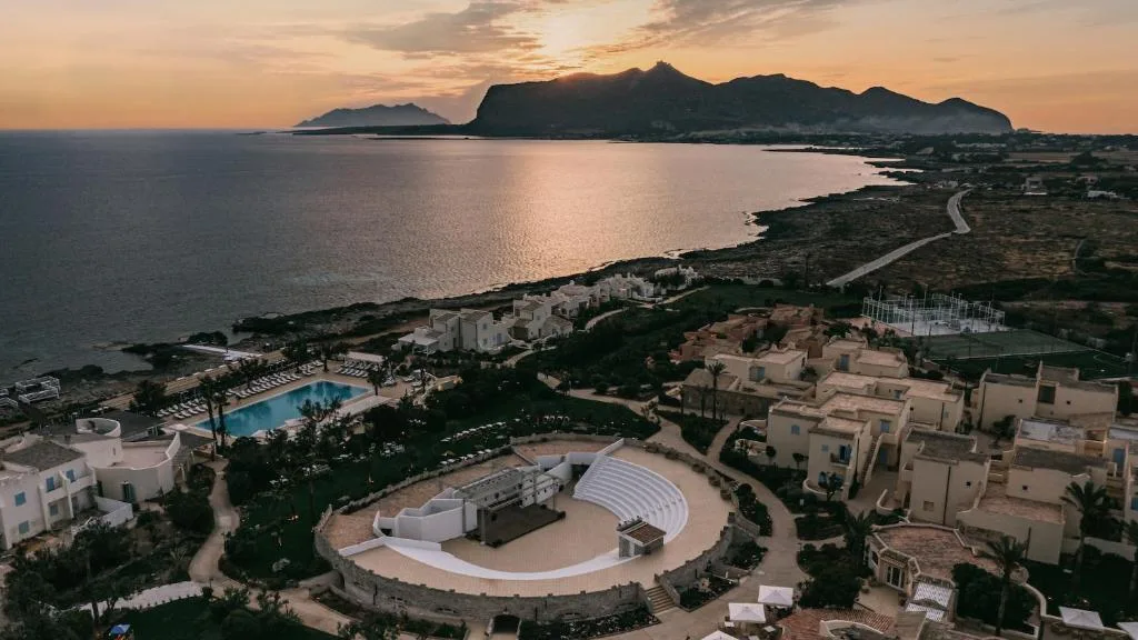 Warm golden hour sunset casting light over the scenic coastal landscape of Favignana, Sicily.