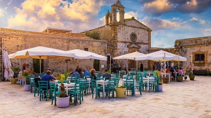 Panoramic view of the picturesque seaside village and turquoise Mediterranean waters in Marzamemi, Sicily.