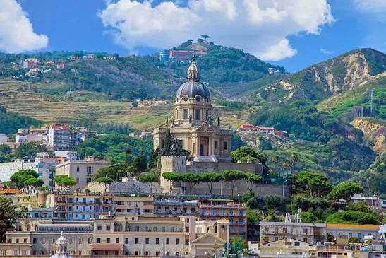Breathtaking panoramic view overlooking the historic coastal cityscape and the scenic Strait of Messina in Sicily.