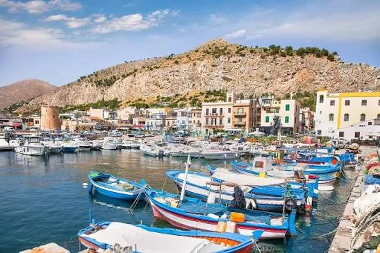 Classic Mediterranean coastal promenade and elegant historic architecture bathed in warm sunlight in Mondello.
