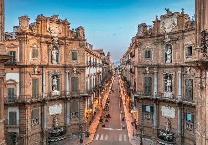 Elegant historic public square illuminated by golden hour light in Palermo, Sicily.