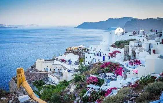 Picturesque view of classic whitewashed island houses and blooming bougainvillea in Panarea, Sicily.