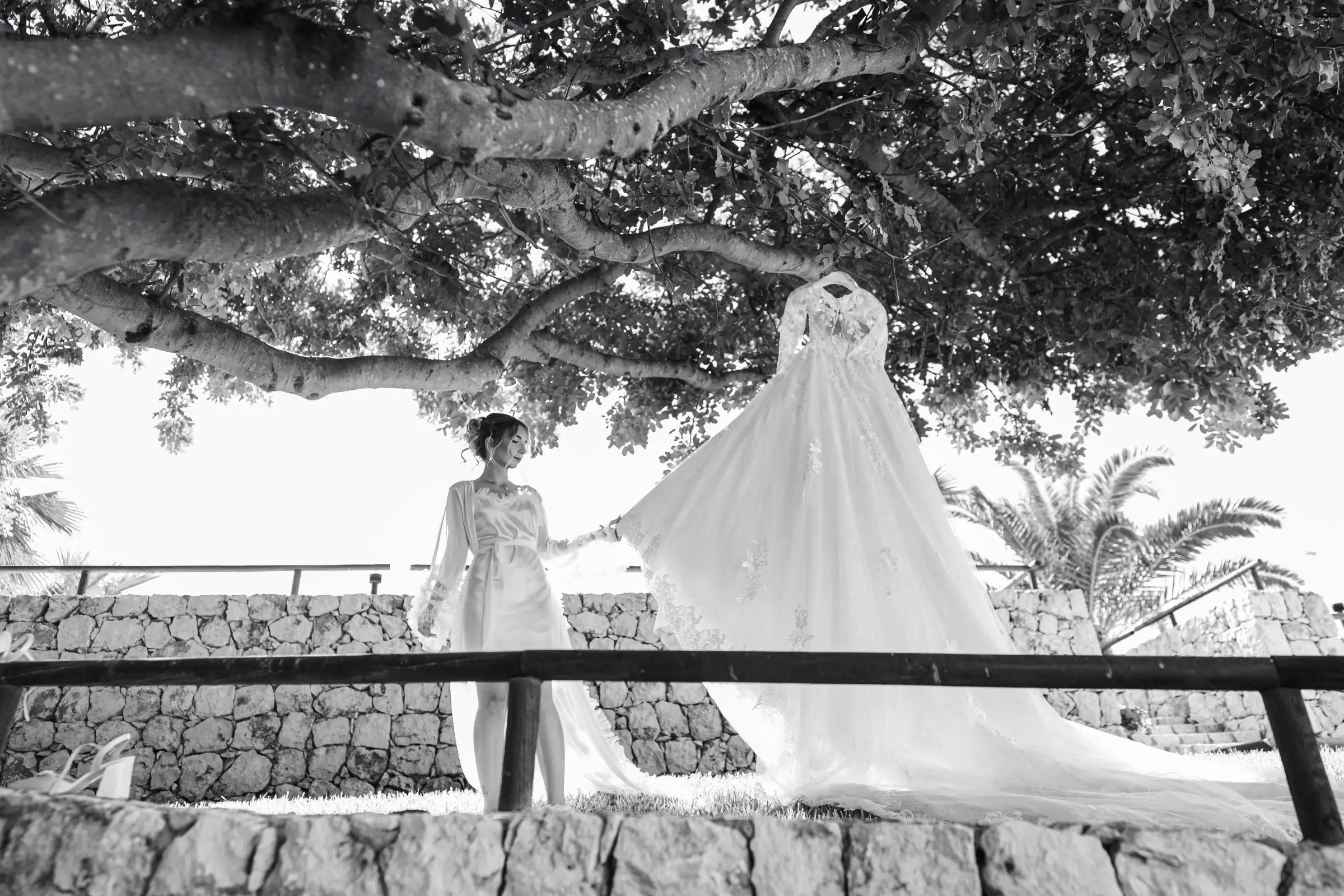Bride looking at her wedding dress hanging