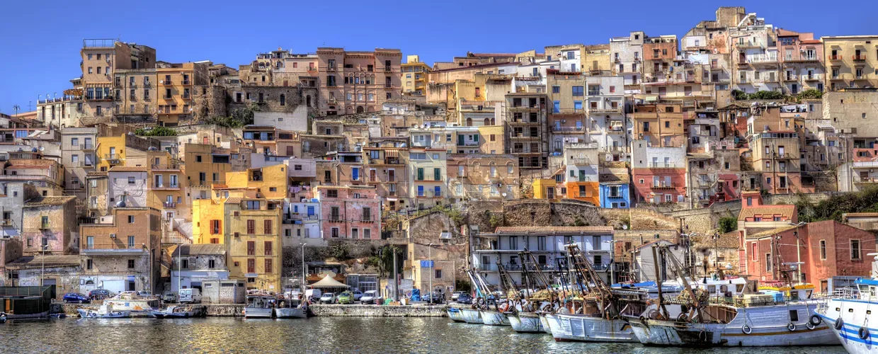 Panoramic view of the colorful seaside town overlooking the sparkling Mediterranean Sea in Sciacca, Sicily.