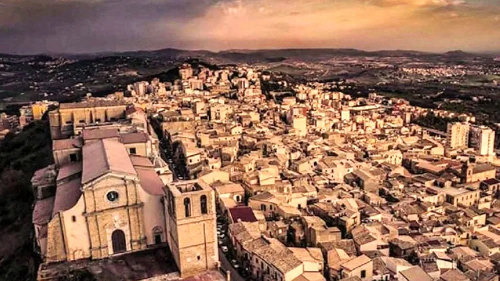 Dramatic sunset landscape overlooking the scenic Mediterranean countryside and ancient ruins in Agrigento.